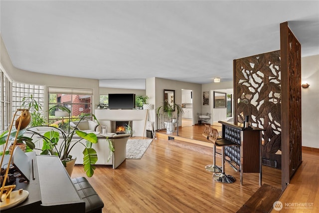 1423 Springwater Ave, Wenatchee, WA 98801 - living room with wood finished floors, a lit fireplace, and baseboards