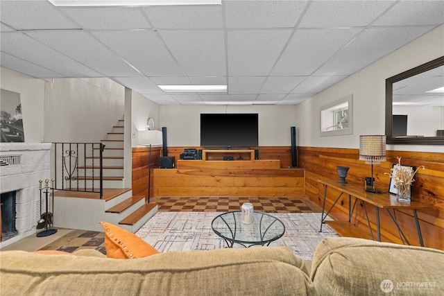 1423 Springwater Ave, Wenatchee, WA 98801 - living room featuring a paneled ceiling, a wainscoted wall, stairway, a fireplace, and wooden walls