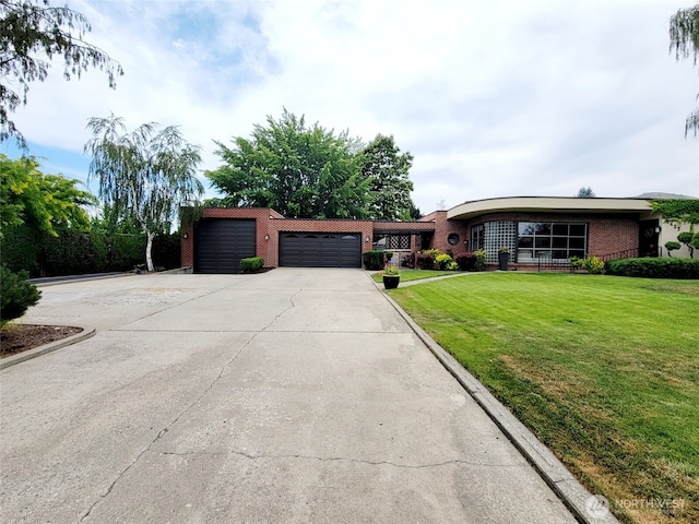 1423 Springwater Ave, Wenatchee, WA 98801 - view of front of home featuring an attached garage, driveway, brick siding, and a front yard