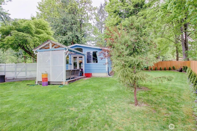 view of outdoor structure with a fenced backyard and central AC