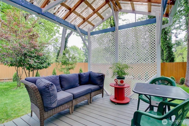 wooden deck featuring outdoor lounge area, fence, and a pergola