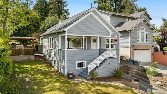view of front of property featuring stairway, driveway, an attached garage, and a shingled roof
