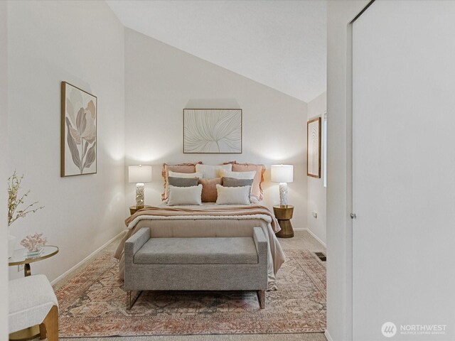 bedroom featuring baseboards, carpet flooring, and high vaulted ceiling