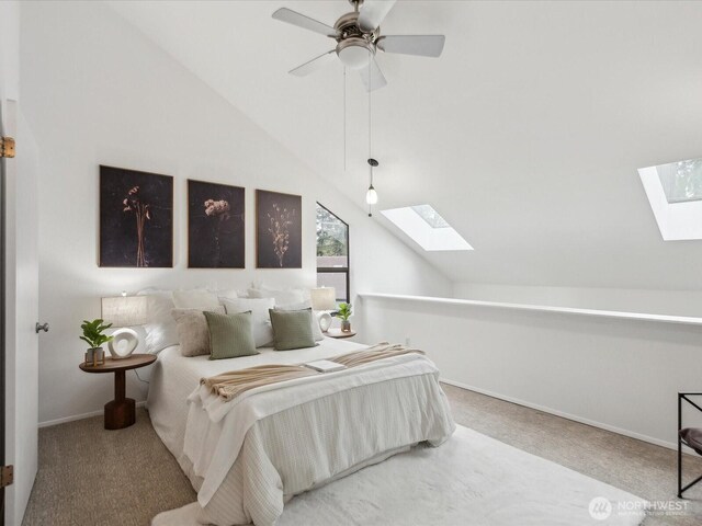 carpeted bedroom with baseboards, a ceiling fan, and lofted ceiling with skylight