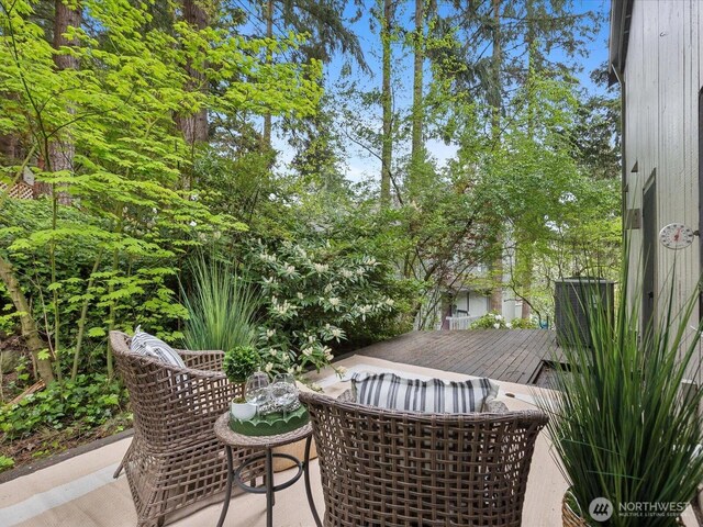 view of wooden balcony featuring a wooden deck and central AC unit