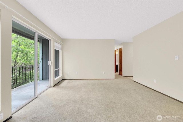 empty room with baseboards and carpet