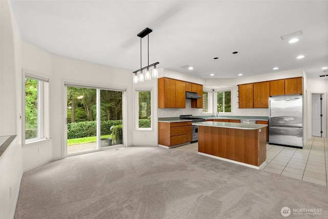 1414 115th Street Ct NW, Gig Harbor, WA 98332 - kitchen featuring a sink, brown cabinetry, stainless steel appliances, under cabinet range hood, and a kitchen island