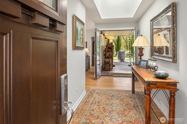 entrance foyer with wood finished floors and baseboards