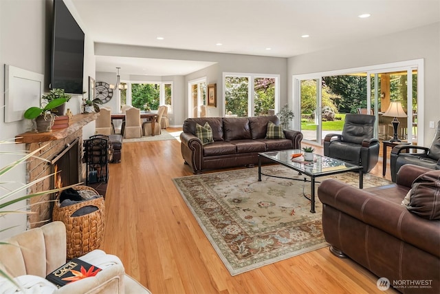 living area with wood finished floors, recessed lighting, and a chandelier