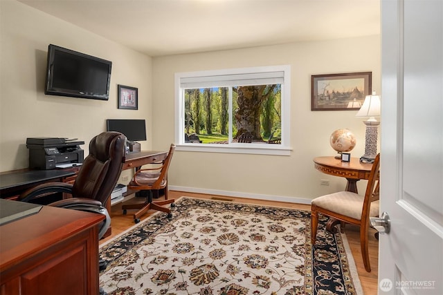 home office with wood finished floors and baseboards