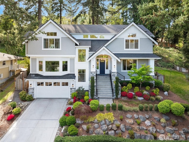 view of front of property with a garage, fence, concrete driveway, a shingled roof, and stone siding