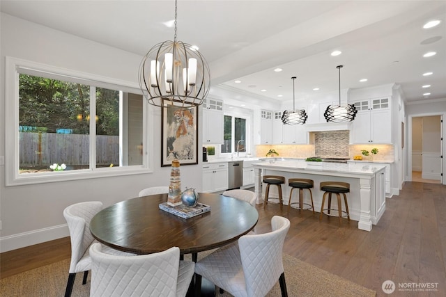 dining room with recessed lighting, baseboards, a notable chandelier, and dark wood finished floors