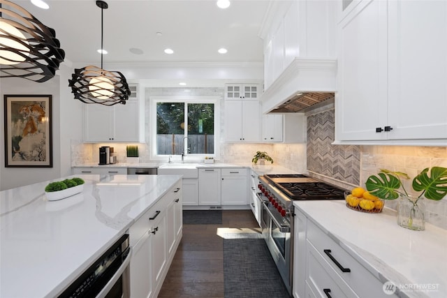 kitchen featuring pendant lighting, decorative backsplash, white cabinets, light stone counters, and double oven range