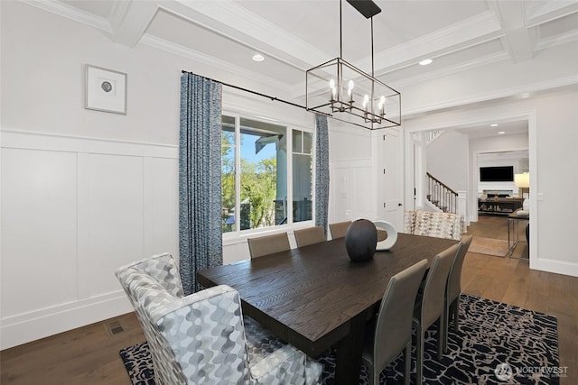 dining space with a decorative wall, dark wood-style flooring, beam ceiling, and a notable chandelier