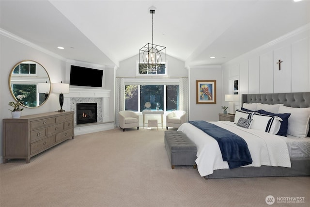 bedroom featuring an inviting chandelier, crown molding, a glass covered fireplace, light carpet, and vaulted ceiling