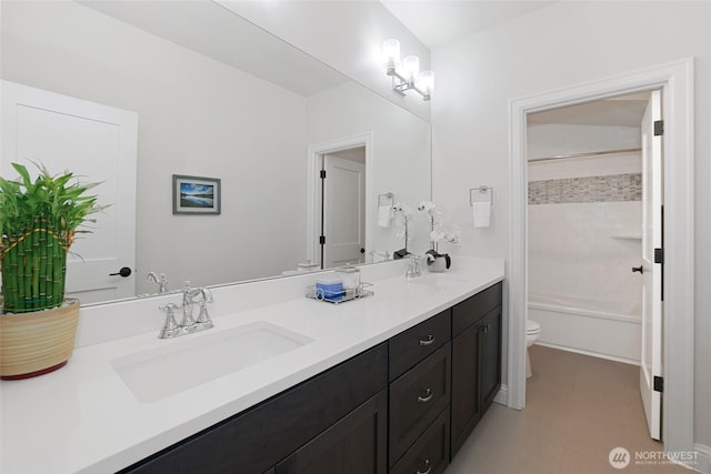full bath featuring double vanity, a sink, shower / bath combination, and toilet