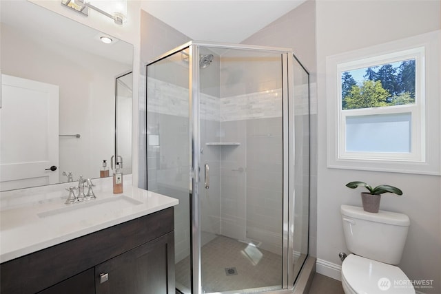 full bathroom featuring vanity, toilet, and a stall shower