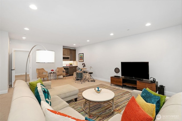 living room with baseboards, light carpet, recessed lighting, and beverage cooler