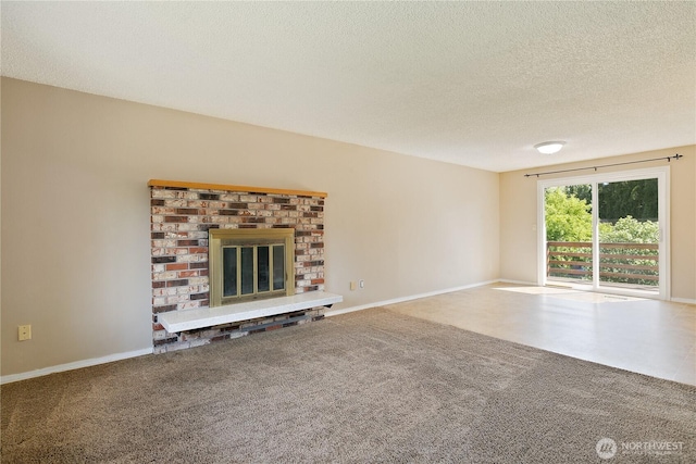 unfurnished living room featuring a textured ceiling, a brick fireplace, carpet floors, and baseboards