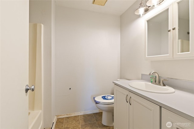 bathroom featuring toilet, vanity, a bathtub, a shower, and baseboards