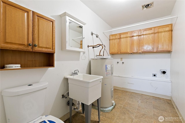 washroom with water heater, hookup for an electric dryer, and cabinet space