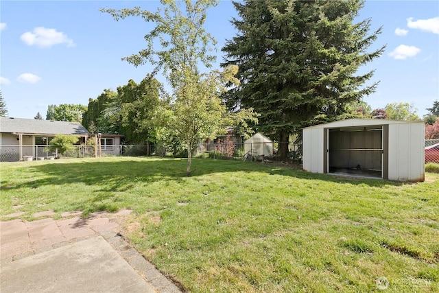 view of yard featuring a storage shed and an outbuilding