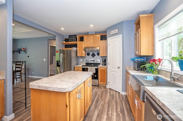 1332 SE Fireweed Rd, Shelton, WA 98584 - kitchen with stainless steel appliances, a sink, under cabinet range hood, open shelves, and light wood-type flooring
