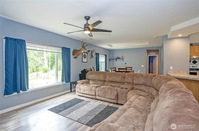 1332 SE Fireweed Rd, Shelton, WA 98584 - living area with healthy amount of natural light, a ceiling fan, wood finished floors, and baseboards