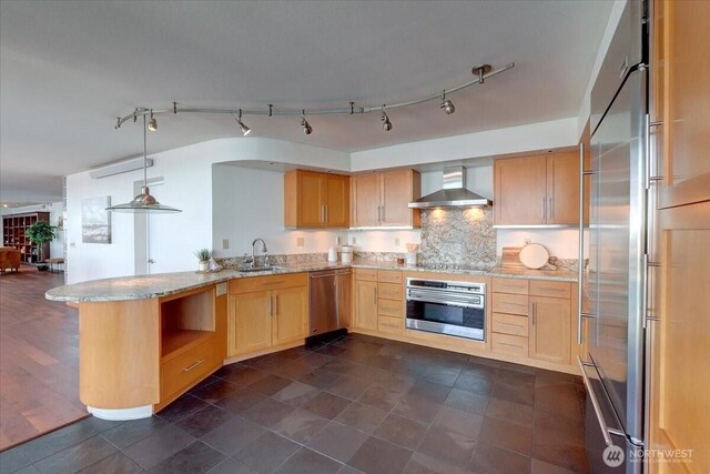 1 N Stadium Way Unit 16, Tacoma, WA 98403 - kitchen featuring stainless steel appliances, wall chimney range hood, light brown cabinetry, a sink, and light stone countertops