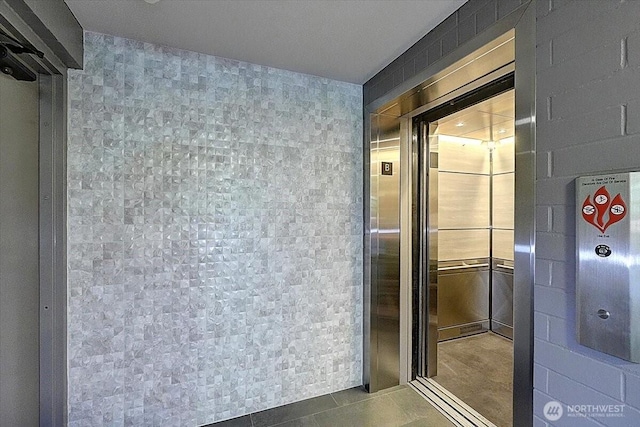 1 N Stadium Way Unit 16, Tacoma, WA 98403 - bathroom with tile patterned flooring, elevator, and tile walls