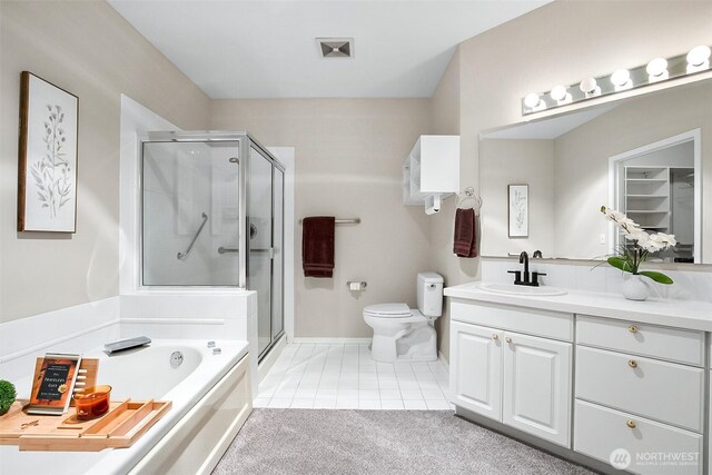 full bath with a bath, tile patterned flooring, a shower stall, vanity, and toilet