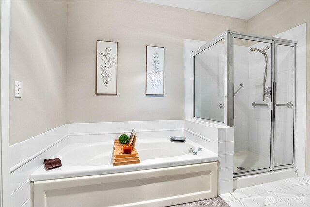 full bathroom featuring a garden tub and a shower stall