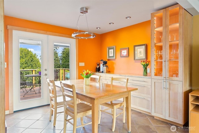 dining space with french doors, light tile patterned flooring, and recessed lighting
