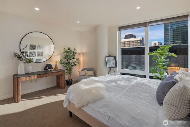 carpeted bedroom featuring baseboards and recessed lighting