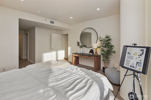 carpeted bedroom with visible vents and recessed lighting