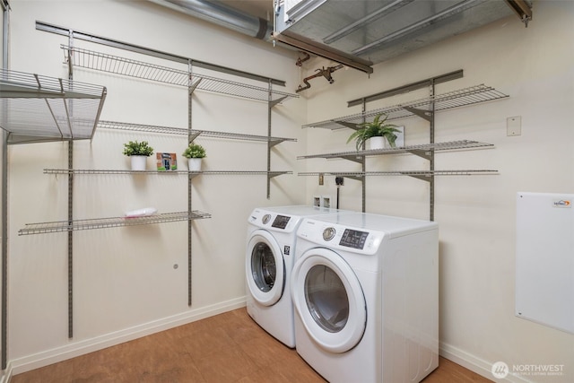 laundry room with washer and dryer, baseboards, and laundry area