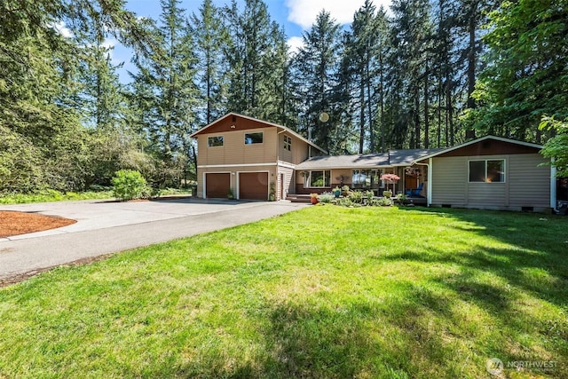 view of front facade with an attached garage, driveway, and a front lawn