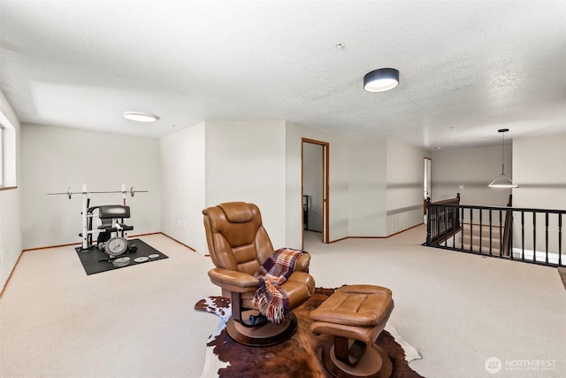 living area featuring an upstairs landing, carpet floors, and baseboards