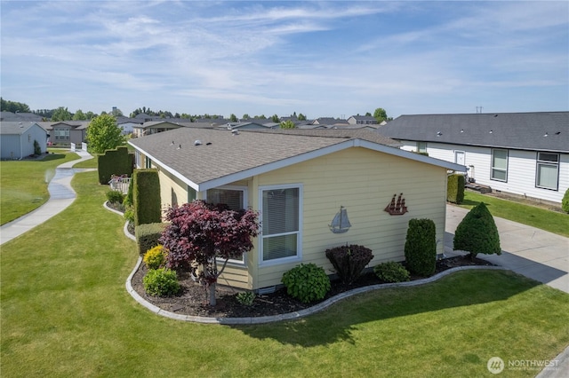 1701 E Burr Ave Unit 12, Moses Lake, WA 98837 - view of side of home featuring a residential view, a lawn, and roof with shingles