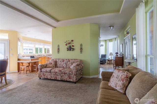 1701 E Burr Ave Unit 12, Moses Lake, WA 98837 - living area with healthy amount of natural light, baseboards, light colored carpet, and light tile patterned flooring