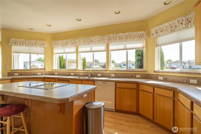 1701 E Burr Ave Unit 12, Moses Lake, WA 98837 - kitchen featuring white dishwasher, healthy amount of natural light, a breakfast bar area, electric stovetop, and recessed lighting