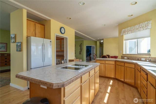 1701 E Burr Ave Unit 12, Moses Lake, WA 98837 - kitchen with light wood-type flooring, black electric stovetop, freestanding refrigerator, a center island, and recessed lighting