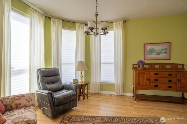 1701 E Burr Ave Unit 12, Moses Lake, WA 98837 - sitting room with a chandelier, light wood finished floors, healthy amount of natural light, and baseboards