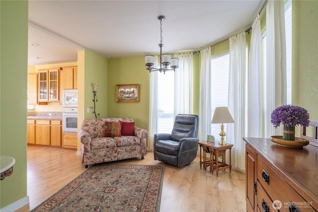 1701 E Burr Ave Unit 12, Moses Lake, WA 98837 - living area featuring a chandelier and light wood finished floors