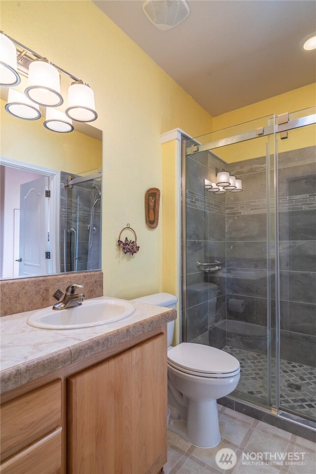 1701 E Burr Ave Unit 12, Moses Lake, WA 98837 - bathroom with vanity, a stall shower, toilet, and tile patterned floors
