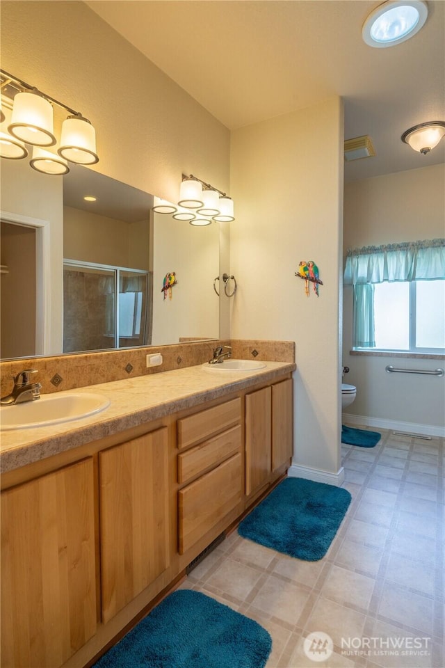 1701 E Burr Ave Unit 12, Moses Lake, WA 98837 - bathroom featuring a stall shower, double vanity, toilet, and baseboards