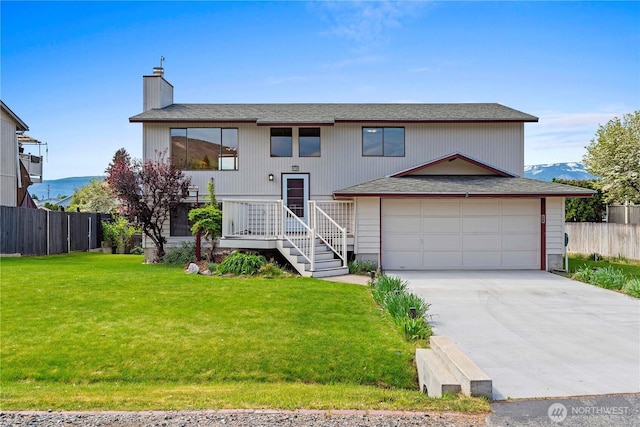 920 11th St NE, East Wenatchee, WA 98802 - split foyer home featuring concrete driveway, a chimney, and a shingled roof