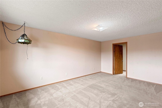 920 11th St NE, East Wenatchee, WA 98802 - unfurnished room featuring light carpet, baseboards, and a textured ceiling