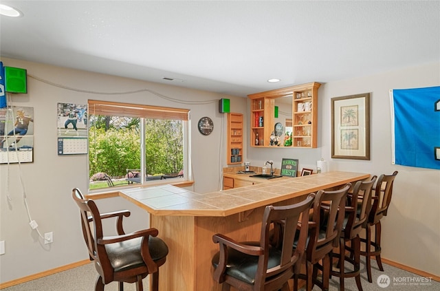 bar featuring recessed lighting, carpet, baseboards, and indoor wet bar
