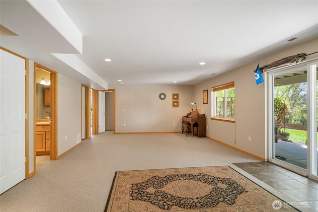 entryway featuring baseboards, light carpet, and recessed lighting